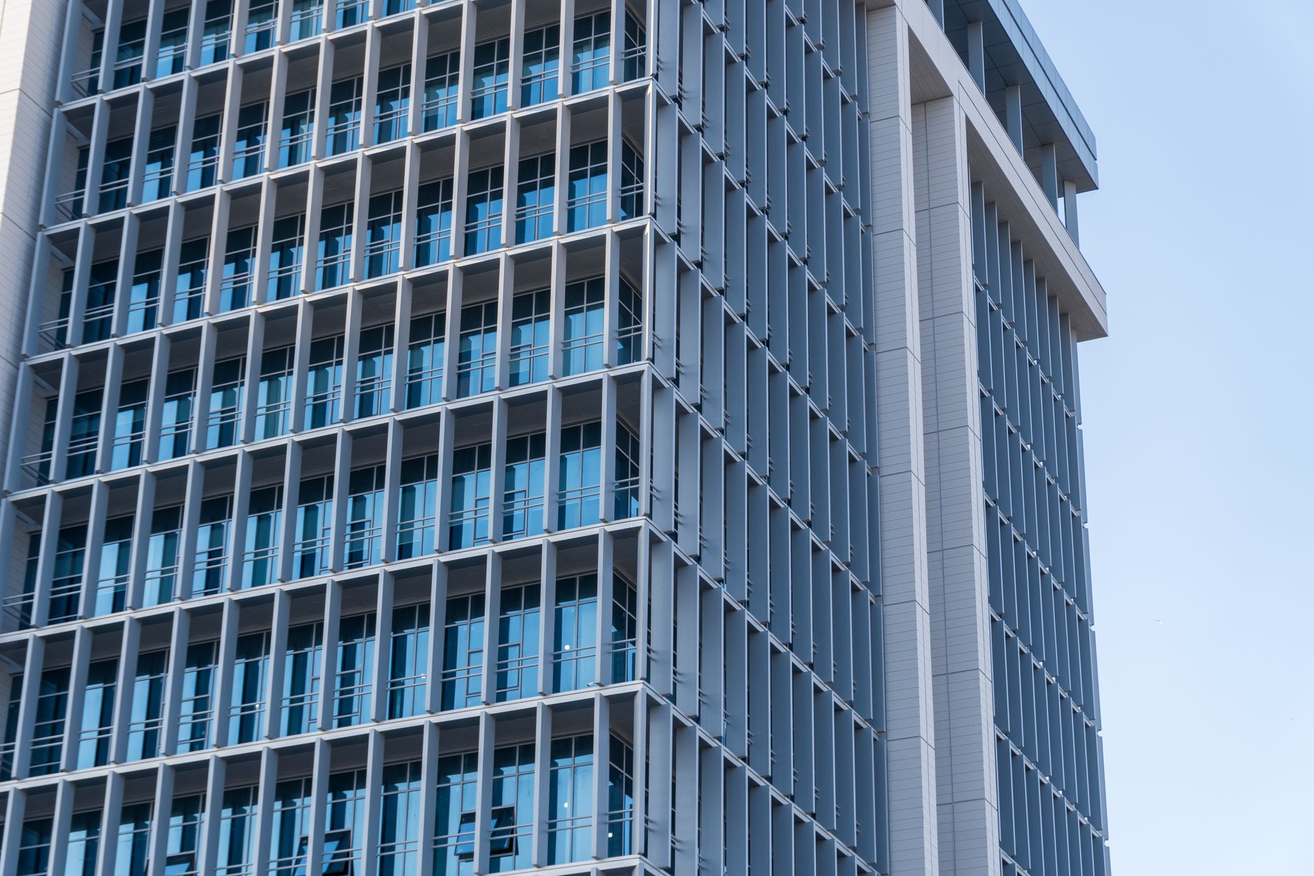 Exploring the sleek design of a modern high-rise office building featuring a glass facade.